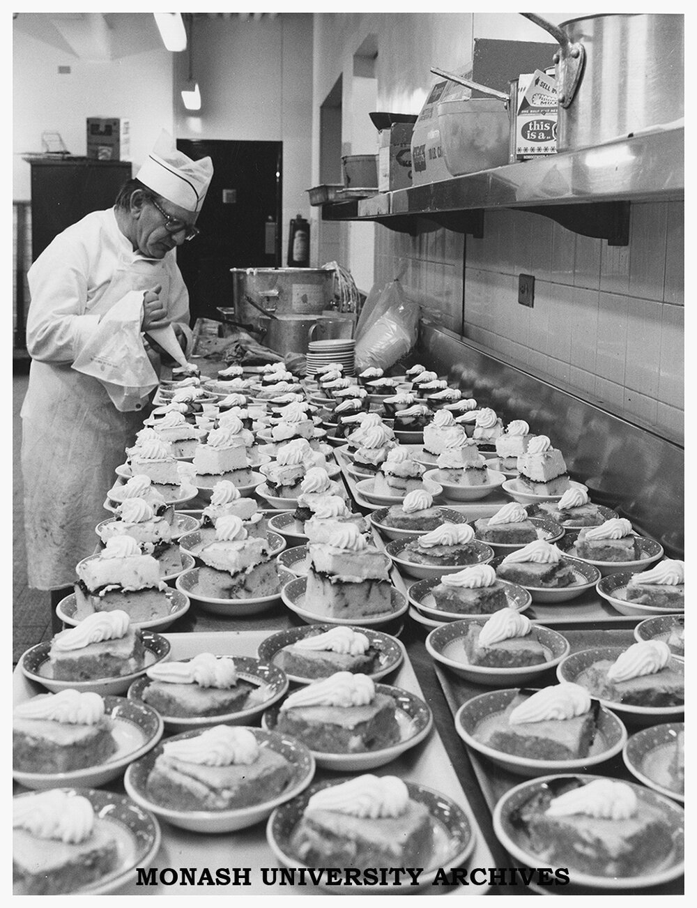 A catering staff member preparing desserts