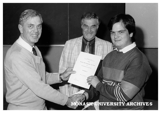 Dr A. Gittins presenting BHP Prize to Bruce Crawford. Professor R. W. Cahn of Cambridge University looking on