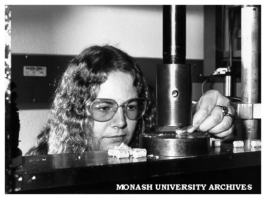 Animal technician Ms Alecia Jones feeding food pellet into compression rig