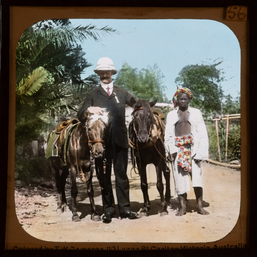 Travellers posing with horses and Indonesian people