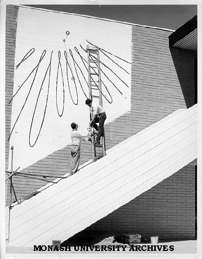 Dr Carl Moppert and Ben Laycock working on sun dial on wall of Union building