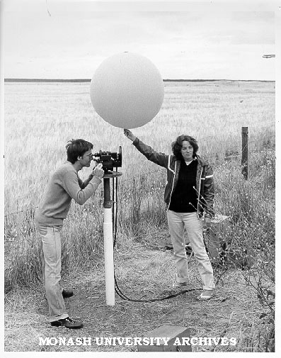 Student Cathy Joyce releasing helium filled balloon to be tracked by double theodolites