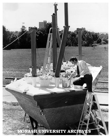 Dr Jon Hinwood inspecting Scylla, undergoing refurbishment prior to launch in Hobson's Bay