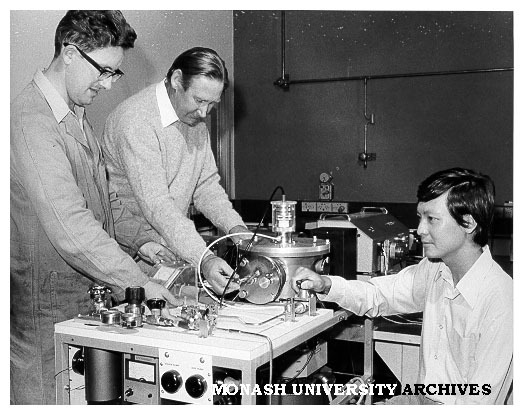 Technical officer Mervyn Roberts (left), Dr Alex McLaren and Dr Ig Tsong, with ion beam spectochemical analyser (IBSCA)