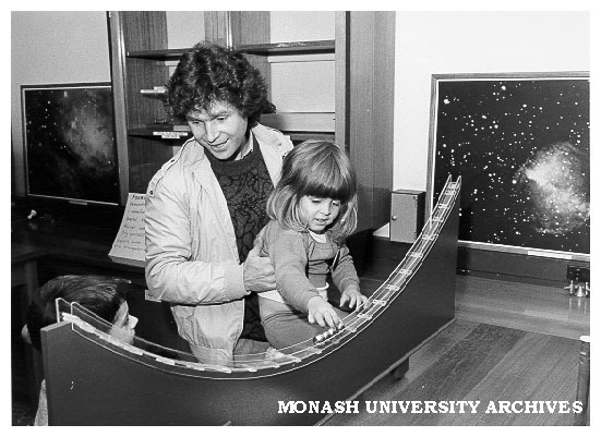 Visitors exploring principles of conservation of momentum