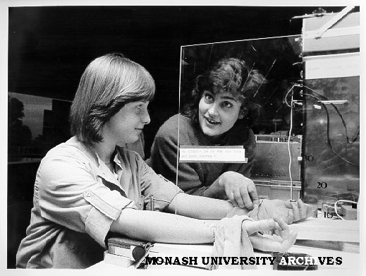 Student Deeta Kimber (right) helping Open Day visitor Vinessa Homer (left) experience sensory illusion