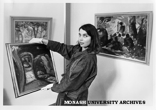 Acting Curator of Visual Arts gallery Elaine Merkus with paintings presented by Dr Clem and Mrs Nina Christensen