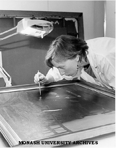 Conservator Robin Sloggert working on Percy Leason's 'The Artists Studio'