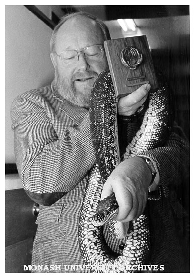 Recipients of 25 year medalliion, laboratory manager Mr Jim Guthrie and python Horace