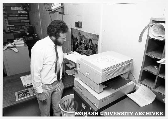 Systems programmer Ron Sawyer using laser printer in Computer Centre office