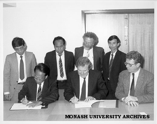 Signing of Memorandum of Understanding between Monash and University of Phnom Penh. from front left: Mr Ek Sam Ol, Professor Mal Logan, Dr David Chandler; rear: Mr Im Sethy, Mr Keou Soeun, A/Prof. Leo West, Mr Pit Chamnan