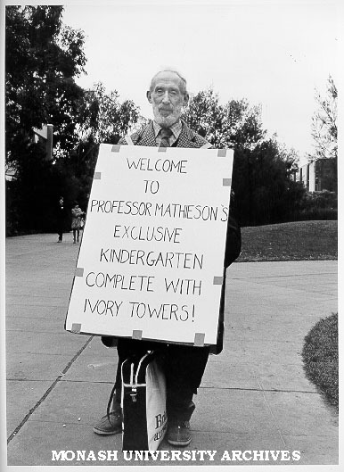 Sandwich board demonstrator. 'Welcome to Professor Mathieson's Exclusive Kindergarten Complete With Ivory Towers!'