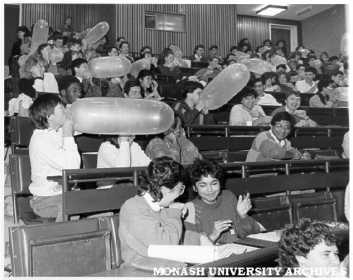 Third year medical students blowing-up condoms