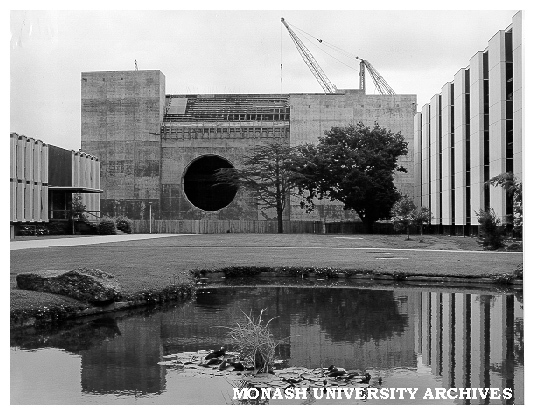 Great Hall under construction, from west framed by Main Library right, and University Offices, left