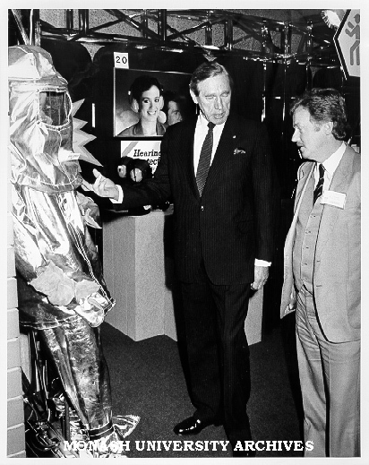 Sir Brian Murray examining Drager Proximity Suit on display at Occupational Health and Safety Convention