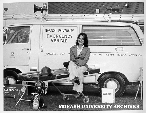 Student Julie Roberts in front of emergency vehicle