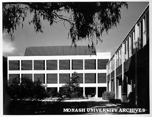 Biomedical library, north side framed by tree with Science building on right