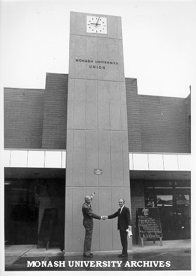 Warden Mr Graeme Sweeney (right) thanking President of Friends of Monash for the Union clock