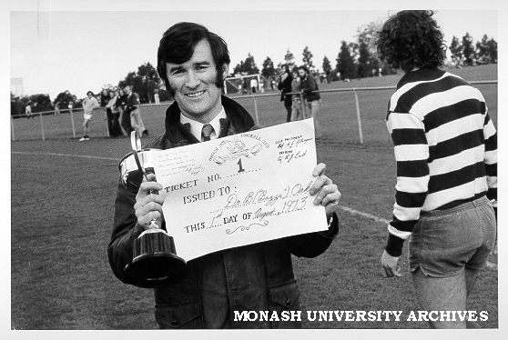 Dr Barry Oakes number one ticket holder for Monash Medicine II football team with CIBA cup presented to Monash captain
