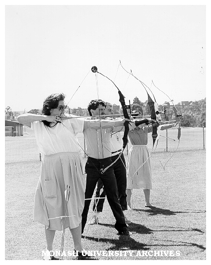 Archery Club members Natalie Tampion, Nick Hatzipantelis, David Maccora [and ?], practising behind Sports and Recreation Centre