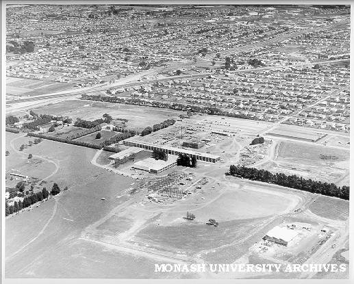 Aerial view of Science buildings under construction, March 1961, from east with Clayton in background