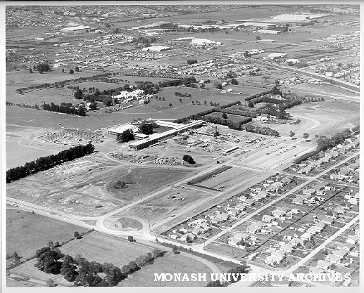 Aerial view of Science buildings under construction, March 1961, from north-west, with Wellington and Dandenong roads in background