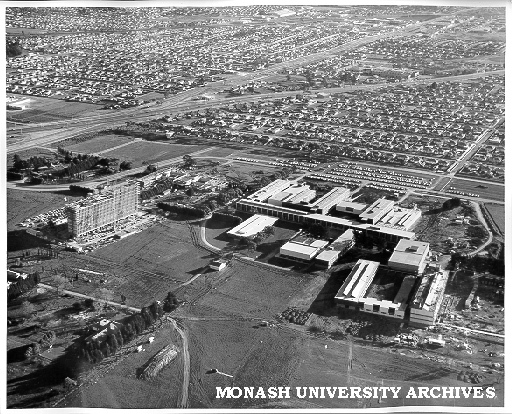 Aerial view of building construction, July 1962, from east, with Clayton in background