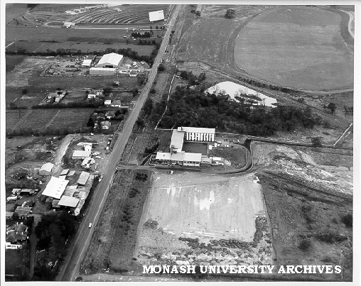 Aerial view of halls site, December 1963, from north with sports oval and drive-in in background
