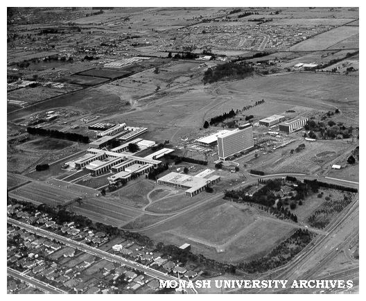 Aerial view of site and buildings, January 1964, from south west with intersection of Wellington and Dandenong roads in foreground