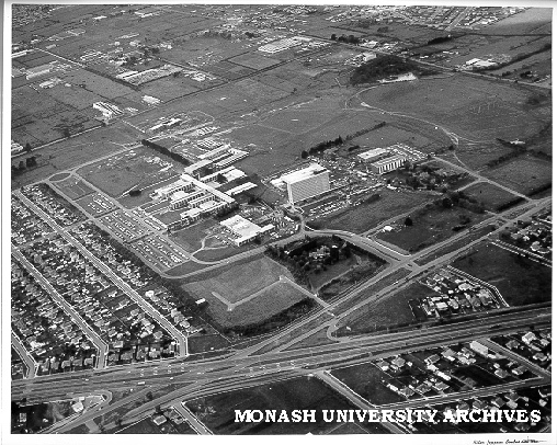 Aerial view of site and buildings, January 1964, from the south west with intersection of Wellington and Dandenong roads in foreground