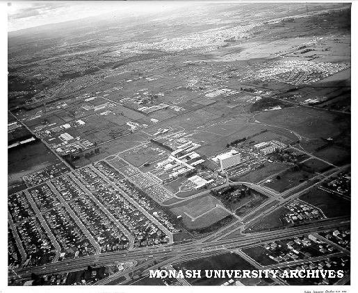 Aerial view of site and buildings, July 1964, from south west with Dandenong Road and Clayton suburbs in foreground
