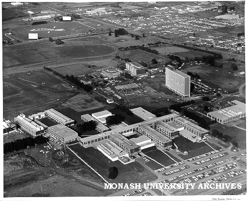 Aerial view of site and buildings, August 1963, from north west with drive-in in background