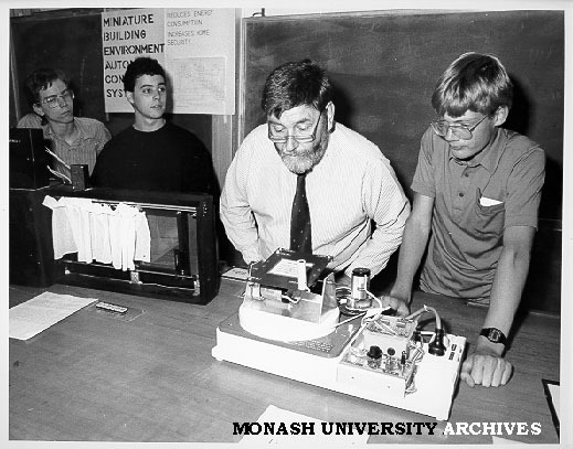 Minister for Science Barry Jones at Science Summer School inspecting solar powered devices designed by Russell Bret (right), Shane McKenzie (far left) and Adam Feldman
