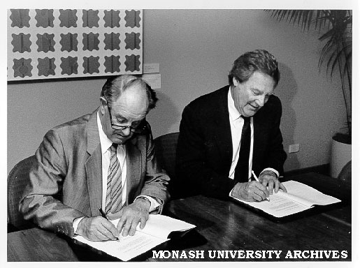 Mr Harry Wragge of Telecom and Professor Mal Logan signing memorandum of understanding to fund Centre for Communications and Information Engineering