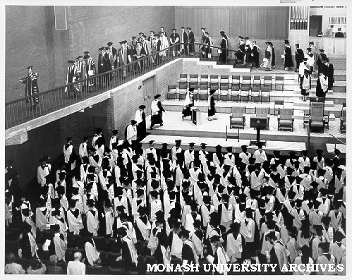 Academic procession leaving stage after graduation ceremony led by Comptroller Mr Len Candy bearing Mace, followed by Chancellor Sir George Lush
