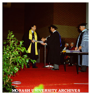 Police Studies graduate Robert Hastings receiving Associate Diploma from President of Council Dr Lionel Ward