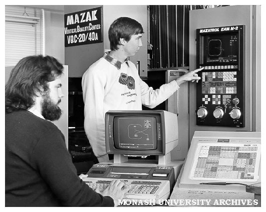 Engineering students, John Simmons (left) and Bruce Olsson, demonstrating CAD-CAM link