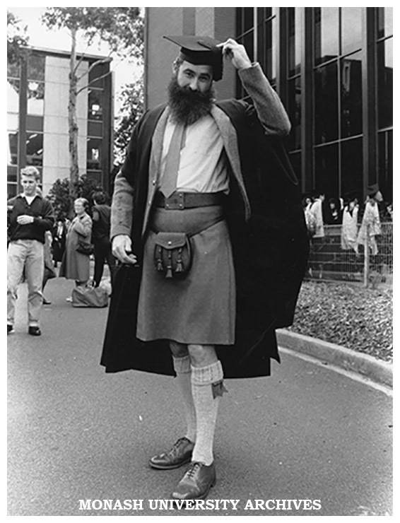 Graduate outside Robert Blackwood Hall