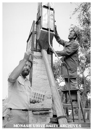 Lecturer Max Murray working on kiln with help of technician Mikhail Nudha