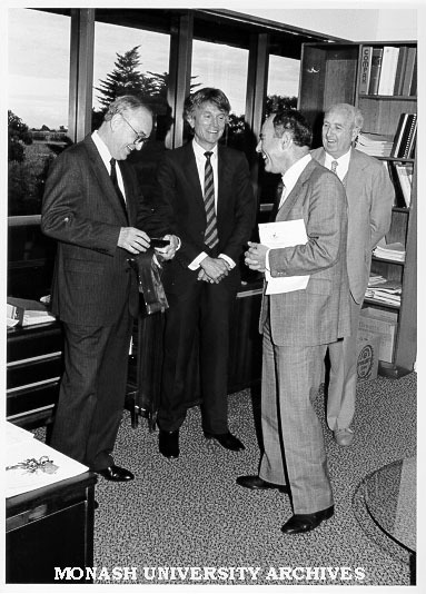 Visiting Professor Norton Bedford of University of Illinois, being presented with David Syme tie and coaster set, with him are Laurie Webb, John Onto and Noel Huggan of Chisholm Business School