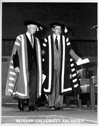 Professor Ray Martin (right) accompanying Sir George Lush to Chancellor's chair for installation ceremony