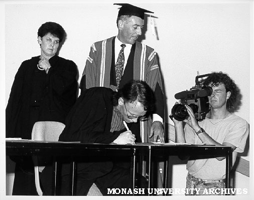 Signing of Monash-GIAE Affiliation agreement. Student representative Mr Peter Shacklock (president of Gippsland Institute Union), Mr Tony Pritchard, Ms Jenny Hill looking on