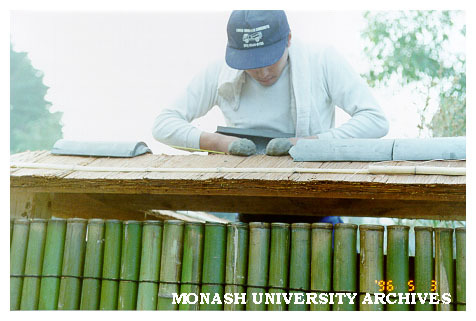 Cutting tiles for roof of Kenninji style fence, Japanese Garden