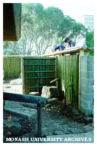 Cutting tiles for roof of Kenninji style fence, Japanese Garden