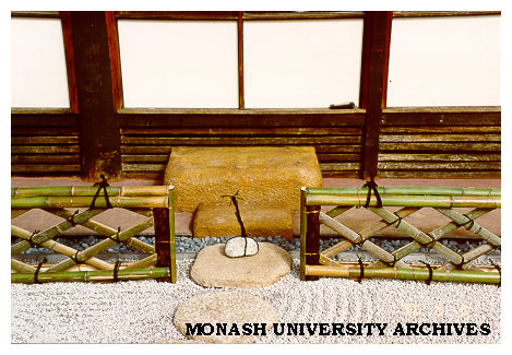 Japanese Garden with stepping stones leading to Kutsunugi stone (shoe removing stone) and Ryoangi style bamboo fence