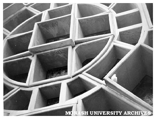 West window, Robert Blackwood Hall with pigeon at rest in the concrete frames