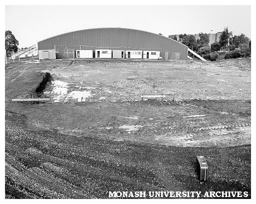 Swimming pool site with sports pavilion in background