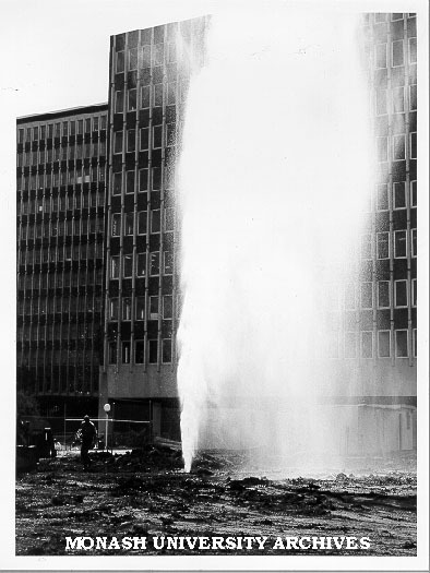Broken water main at site of multidisciplinary centre with Menzies building in background