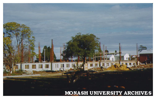 Early construction with original buildings in background