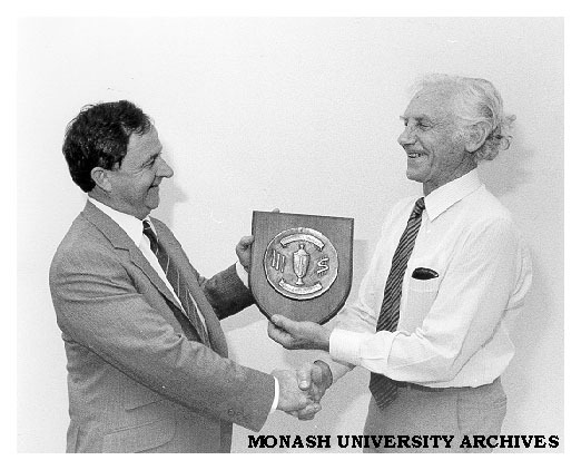 Professor Kevin Westfold presenting cricket trophy to Mr Peter Wade (left) after Comptroller's-versus- Registrar's Westfold memorial cricket match